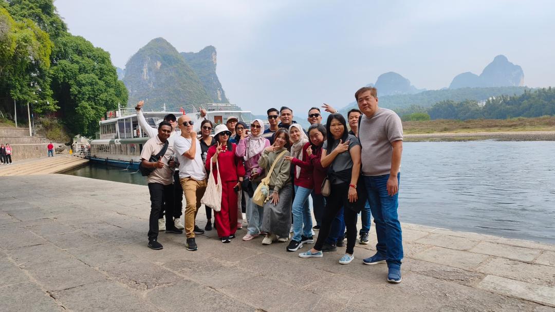 Team group photo by the river, 2025 Company Trip